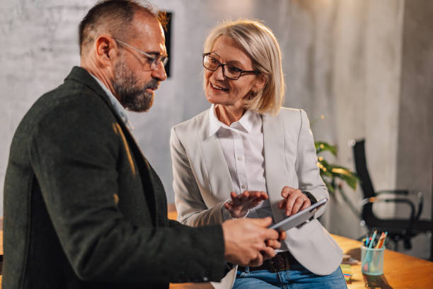 istock Smart causal mature managers brainstorming and discussing project at office 2149591487
