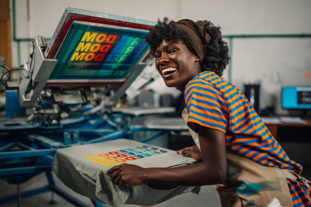 istock Happy interracial worker finishing silk screen printing at workshop. 2149591520