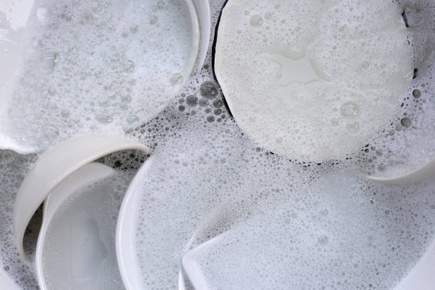 istock Dish washing, Dirty dishes soaking in kitchen sink. 2149593781