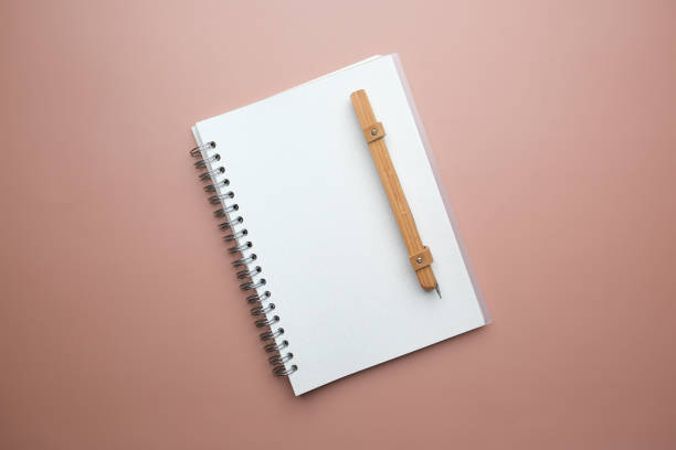 istock The mockup white notebook and wooden pen for dairy, journal, and planner concept. 2149596307