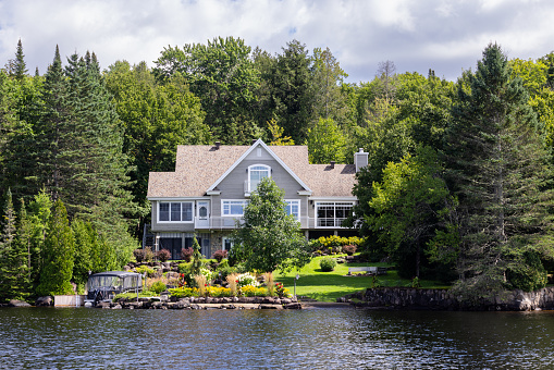 Lac St-Joseph, Quebec, Сanada - August 27, 2023: Luxurious lakefront property located in Lac St-Joseph, a rich suburb of Quebec City on a sunny day of summer.