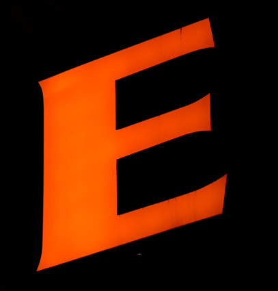 Electric orange 'E' stands out against the black, its three stripes symbolizing energy and dynamism