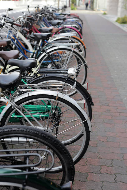 istock A group of bicycles lined up in a row on the sidewalk. 2149602636