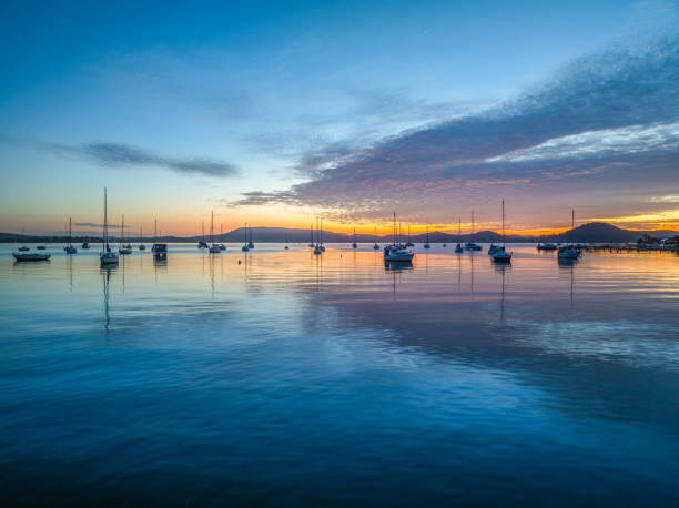 istock Sunrise over the water with boats and reflections 2149602834