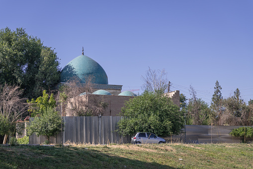 JUNE 26, 2023, TASHKENT, UZBEKISTAN: Mosque in Tashkent on restoration, Uzbekistan. Blue sky with copy space for text, fountain in the front