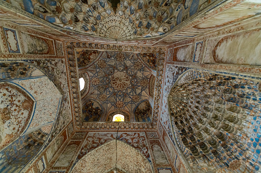 JUNE 27, 2023, BUKHARA, UZBEKISTAN: Awesome view of the inside of unrestored Madrasah in Bukhara, Uzbekistan. The ancient brick tower is a popular tourist attraction of Central Asia