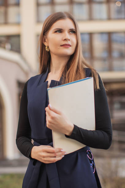 istock real estate agent with folder. Business woman in suit. 2149603369