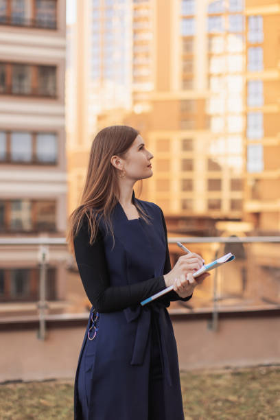 istock real estate agent with folder. Business woman in suit. 2149604501