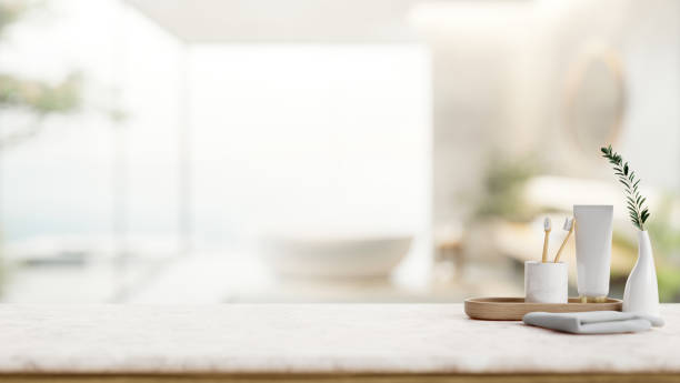 istock A toothpaste, toothbrushes, a towel on a white tabletop in a contemporary bathroom with a bathtub. 2149605508