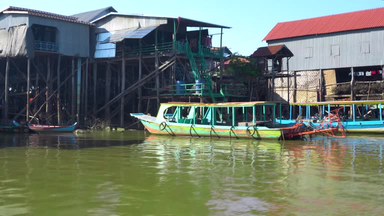 boat trip on the  River in Cambodia. Fishing villages and houses on the water, trees grow in water