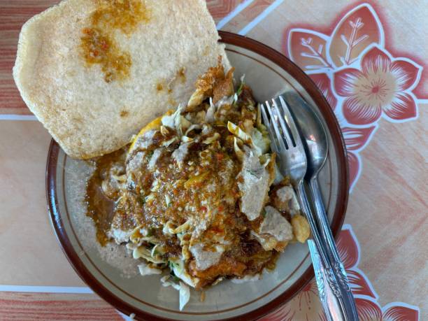 istock Tahu Gimbal, traditional dish from Semarang, Java, Indonesia. Made from rice cake, tofu, bean sprouts, bakwan prawns, sprinkled with peanut sauce, fried peanuts and sliced ​​celery 2149609373