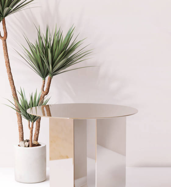 istock Modern and minimal shiny gold pedestal table podium with dracaena tree in sunlight in white room 2149609516
