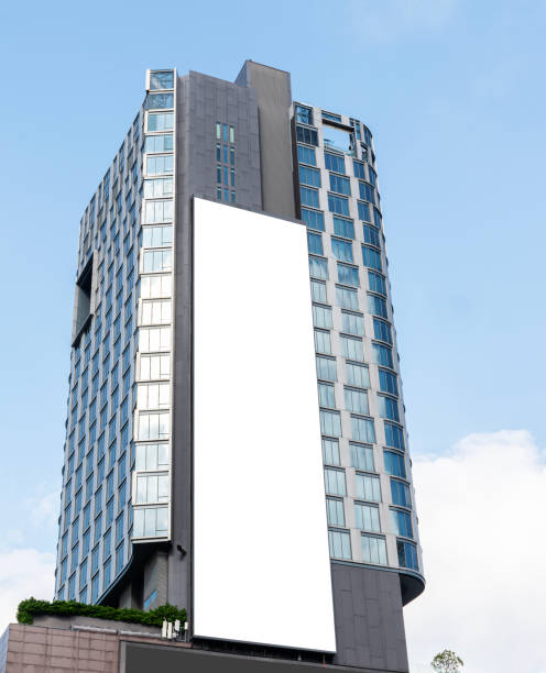 istock Mock up white vertical large LED display billboard on tower building with blue sky background .clipping path for mockup 2149609696