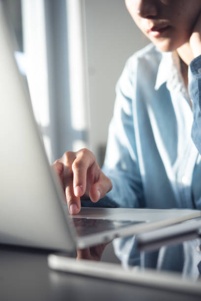 Young asian business woman thinking about problem solving at work. Casual businesswoman searching the information, working on laptop computer with digital tablet on office table