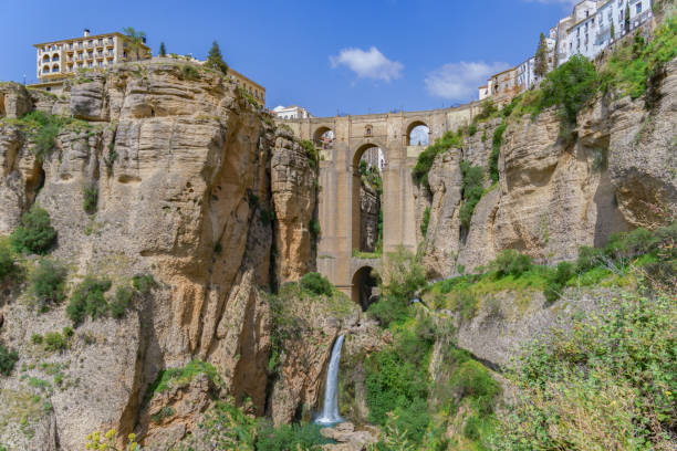 istock ronda ,malaga, spain 04/18/2023 new bridge over the cliff with a waterfall 2149611130