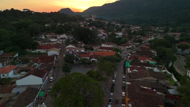 Drone flies over historic center of Tiradentes, Brazil at sunset