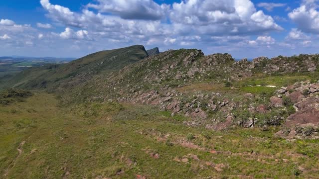 Drone flies over two hikers on Serra do Sao Jose on a beautiful sunny afternoon