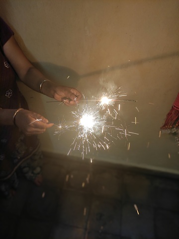 2 sparkler being lit up on the auspicious occasion of Diwali