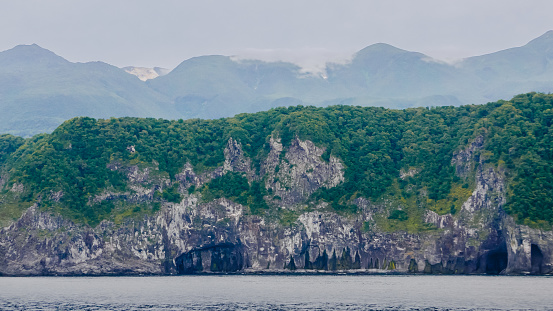 A unique landscape of coastal sheer cliffs and eroded caves on the west edge of a volcanic plateau around the Goko Lakes in Shiretoko Peninsula, East Hokkaido, Japan.