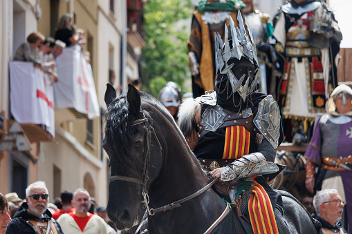 Alcoy, Spain, 04-20-2024: Warrior on horseback of pageantry in the Aragoneses troupe group in the Moors and Christians parade of Alcoy, a festival of international tourist interest since 1980