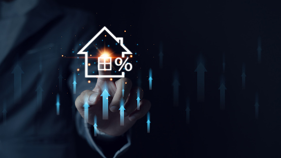 Man touches virtual house icon to analyze home loan and real estate mortgage insurance. interest rate Real estate investment ideas