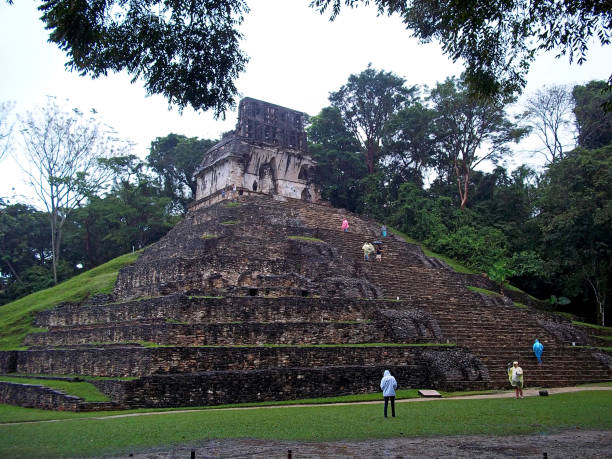 Young Caucasian woman standing on stairs of pyramid in  Tikal National Park