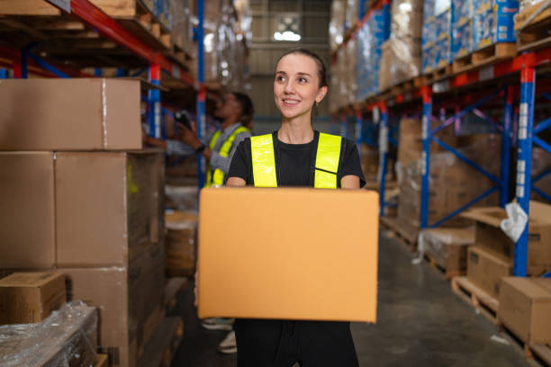 istock warehouse employee worker enjoy working and holding box. 2149615006