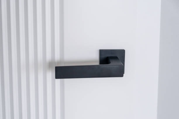 istock Modern black door handle on white wooden door in interior. 2149615581