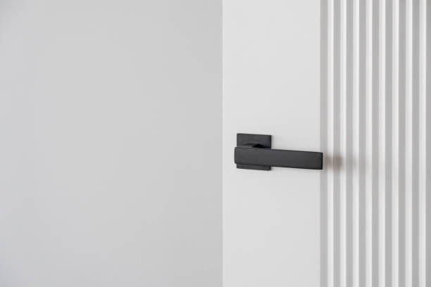 istock Modern black door handle on white wooden door in interior. 2149615620
