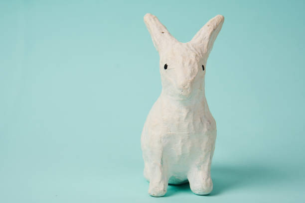 istock Festive white rabbit toy on a blue background with pastel colors Easter 2149615906