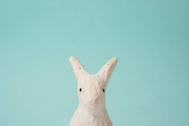 istock Festive white rabbit toy on a blue background with pastel colors Easter 2149616066