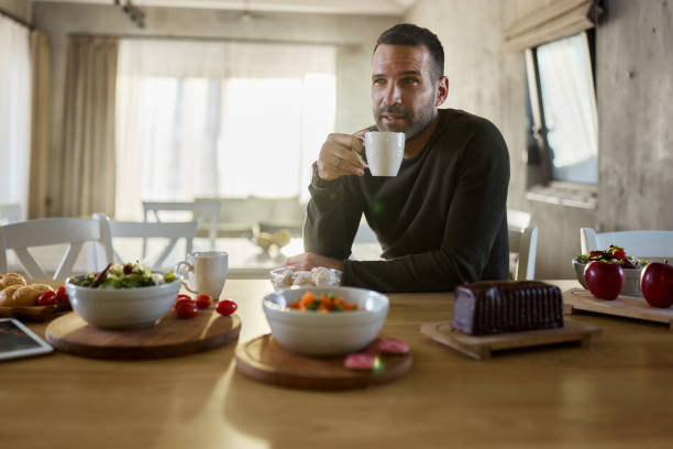 istock Pensive man drinking coffee in dining room. 2149617027