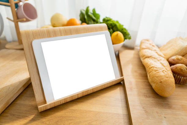 istock Tablet white screen on kitchen table with Vegetables, fruits and bread. Clipping path. Mockup display empty space use for graphic advertising text. Display live food online media. 2149619914