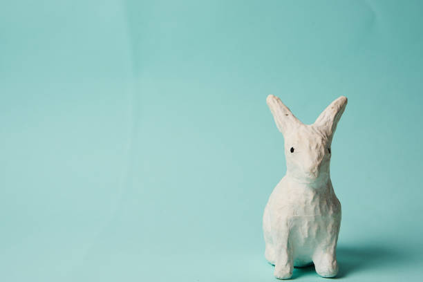 istock Festive white rabbit toy on a blue background with pastel colors Easter 2149620113