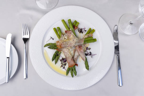 istock Top view of a rolled asparagus served  with cheese on a white plate 2149620865