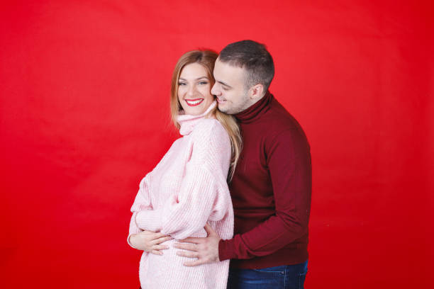 istock Young man holding his girlfriend from behind, she is smiling at camera 2149622272