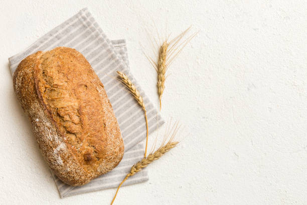 Fresh Homemade Whole Wheat Bread. bread on napkin on rustic background, fresh bread top view
