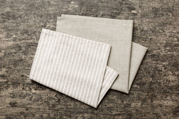 istock top view with gray kitchen napkin isolated on table background. Folded cloth for mockup with copy space, Flat lay. Minimal style 2149622412