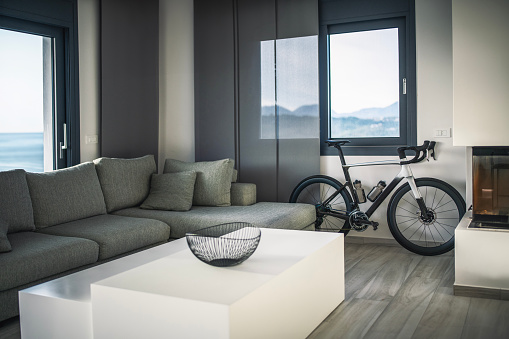 Modern, monochrome interior of living room with a bicycle.