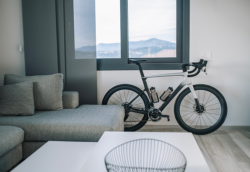Modern, monochrome interior of living room with a bicycle.