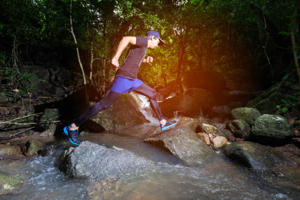 istock Runner, he's running a trail. In a natural path with a stream 2149623380