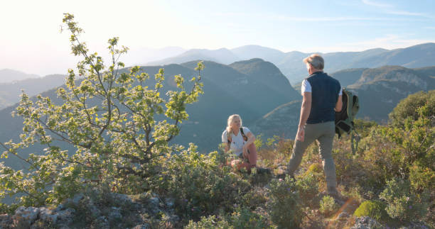istock Mature hikers chat on hilltop 2149624013