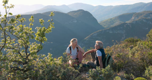 istock Mature hikers chat on hilltop 2149624318