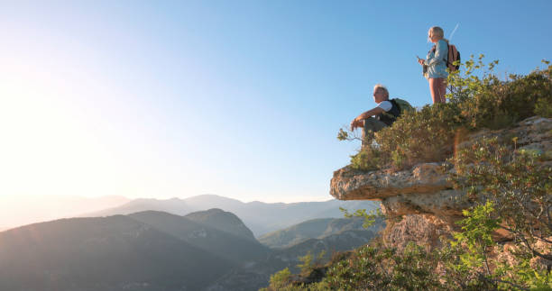 istock Mature hiker pauses on cliff edge 2149624364