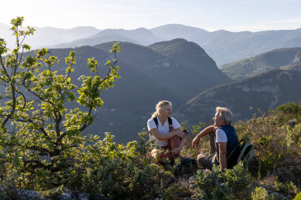 istock Mature hikers chat on hilltop 2149624537