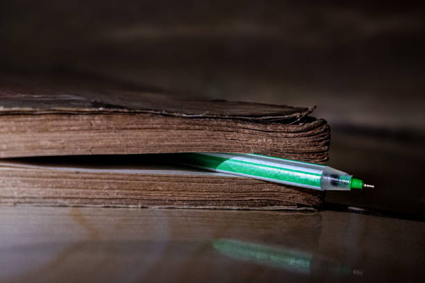 Close up of a thick old book in a basket, a worn book rusty with age.