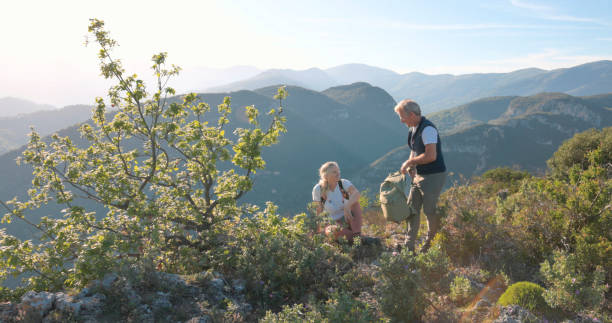istock Mature hikers chat on hilltop 2149624561