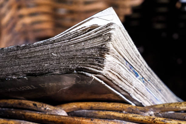 Close up of a thick old book in a basket, a worn book rusty with age.
