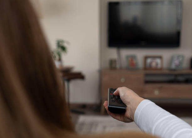 istock Woman watching television on the sofa at home 2149625852