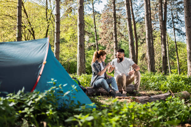 istock Smiling Couple Savoring Coffee Together in Forest 2149627517